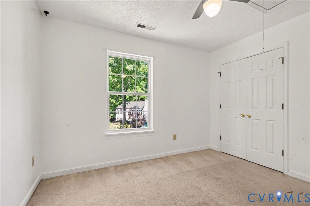 931 Hunters Run Drive, Henrico, VA 23223 Carpeted room featuring a double-hung window, bi-fold closet doors, a ceiling fan with light fixture, and white wall finishes