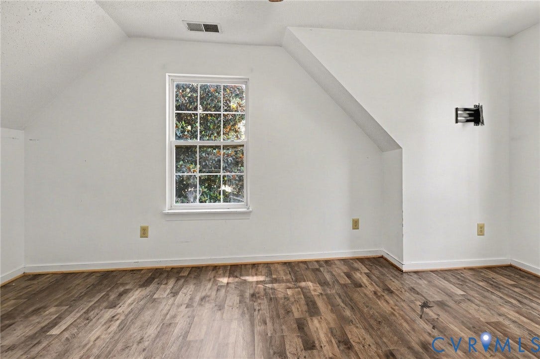 931 Hunters Run Drive, Henrico, VA 23223 Bright interior room featuring a double-hung window, wood-finish flooring, white painted walls, and an angled ceiling