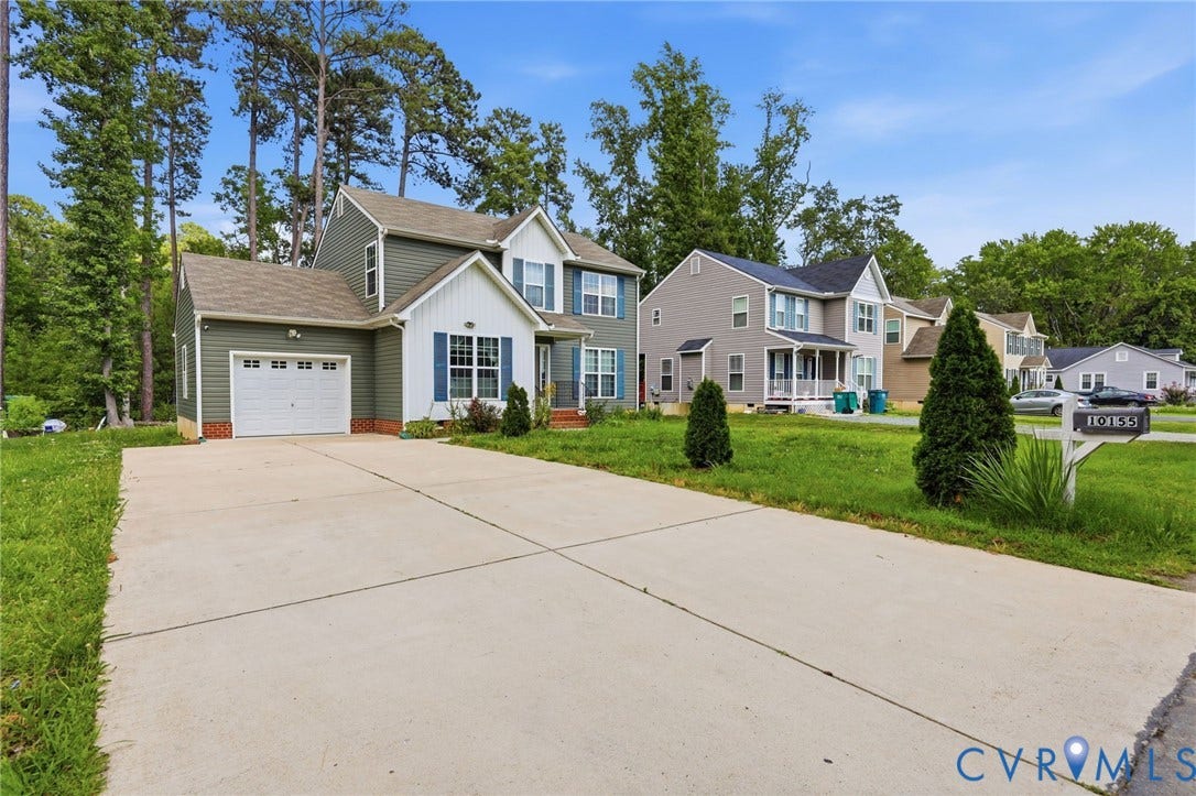 10155 Virginia Road, Glen Allen, VA 23060 Two-story residence featuring green siding with white trim and blue shutters