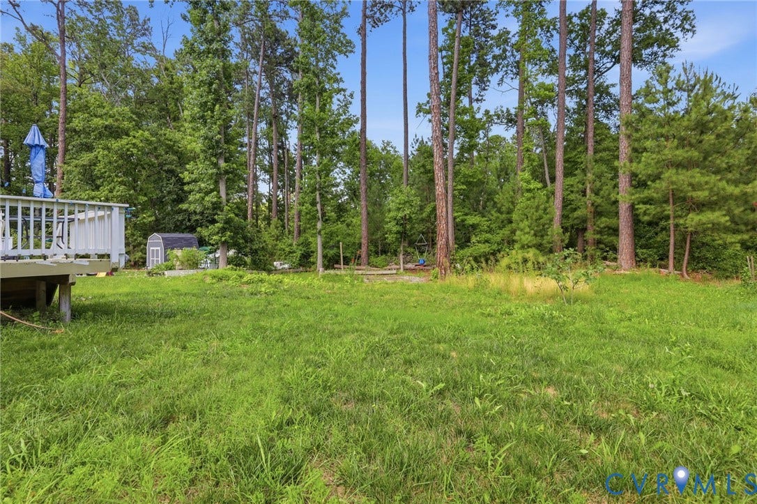 10155 Virginia Road, Glen Allen, VA 23060 Expansive green yard with a wooden deck featuring white railings