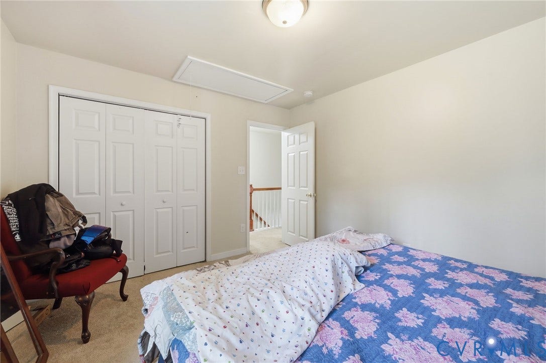 10155 Virginia Road, Glen Allen, VA 23060 Room featuring neutral wall tones, carpeted flooring, a flush-mount ceiling light, and a bi-fold closet