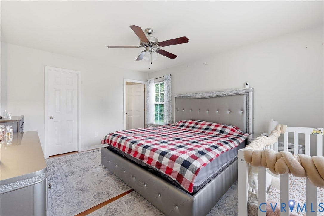 10155 Virginia Road, Glen Allen, VA 23060 Bedroom featuring a ceiling fan with light fixture, white walls, and a window with natural light
