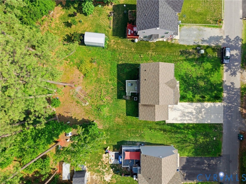 10155 Virginia Road, Glen Allen, VA 23060 Aerial property view showcasing a light brown shingled roof, a paved driveway, and an expansive green lawn