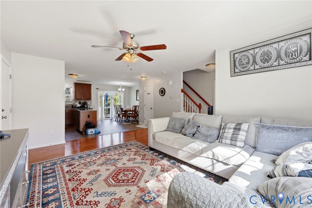 10155 Virginia Road, Glen Allen, VA 23060 Spacious living area featuring wood-finish flooring, a ceiling fan with light fixture, and white wall finishes