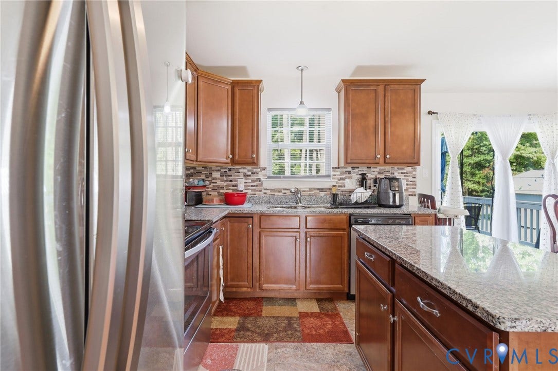 10155 Virginia Road, Glen Allen, VA 23060 Kitchen featuring wood cabinetry, granite countertops, tile backsplash, and stainless steel appliances