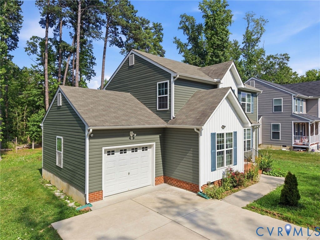 10155 Virginia Road, Glen Allen, VA 23060 Two-story residence featuring green horizontal siding and white vertical siding accents