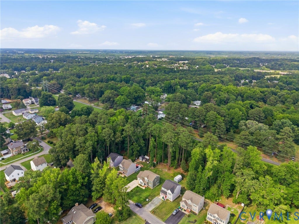 10155 Virginia Road, Glen Allen, VA 23060 Expansive aerial perspective showcasing a residential area surrounded by abundant mature trees and verdant landscapes