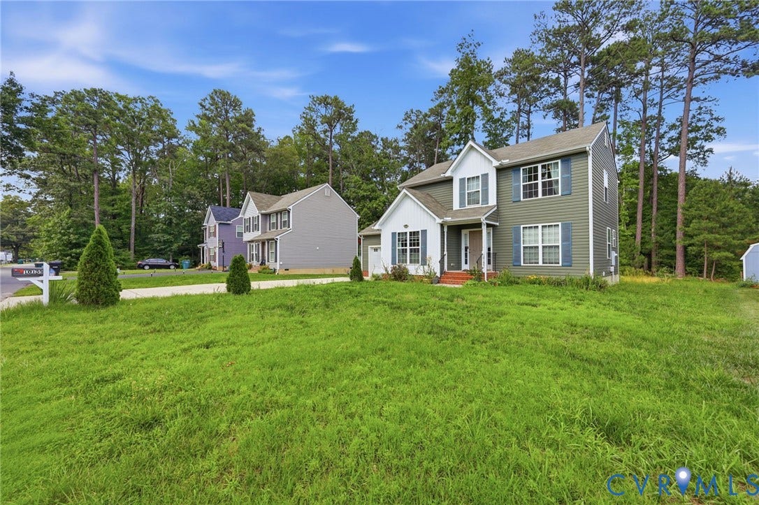 10155 Virginia Road, Glen Allen, VA 23060 Two-story residence featuring light green and white siding, blue shutters, and a front entry with a small porch