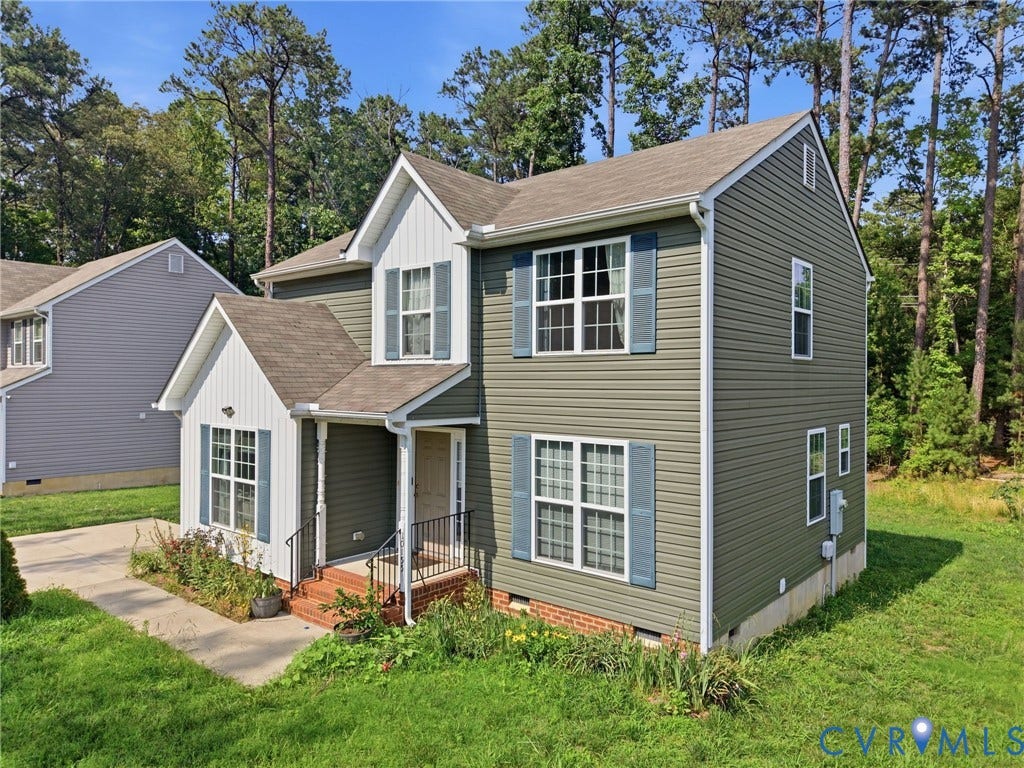 10155 Virginia Road, Glen Allen, VA 23060 Two-story residence featuring green and white siding, blue decorative shutters, and a front porch with black railings