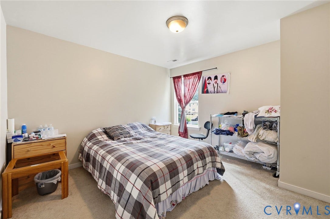 10155 Virginia Road, Glen Allen, VA 23060 Carpeted room with neutral wall tones and a window featuring vertical blinds