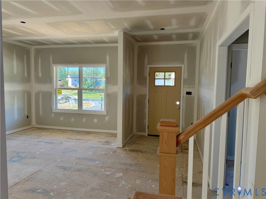 11130 Somerset Bluff Court, Somerset Hills, Glen Allen, VA 23059 New construction interior featuring a wood-finish entry door with glass inserts, a double-hung window, and an unfinished wood-finish staircase with white balusters