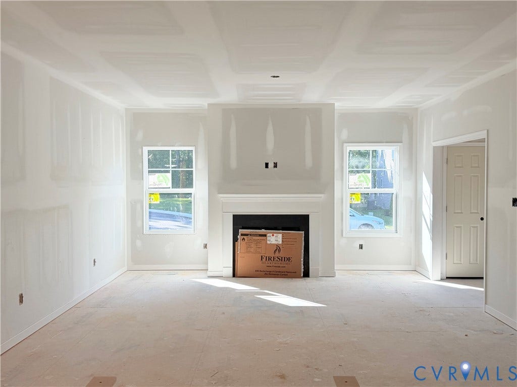 11130 Somerset Bluff Court, Somerset Hills, Glen Allen, VA 23059 Spacious room with a fireplace, mantel, and symmetrical windows, featuring an open doorway and crown molding