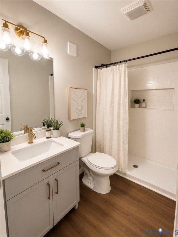 3909 Corbin Street, Wahington Park, Richmond, VA 23222 Bathroom featuring a light gray vanity with brass hardware, a white countertop with integrated sink, and a gold-finish faucet