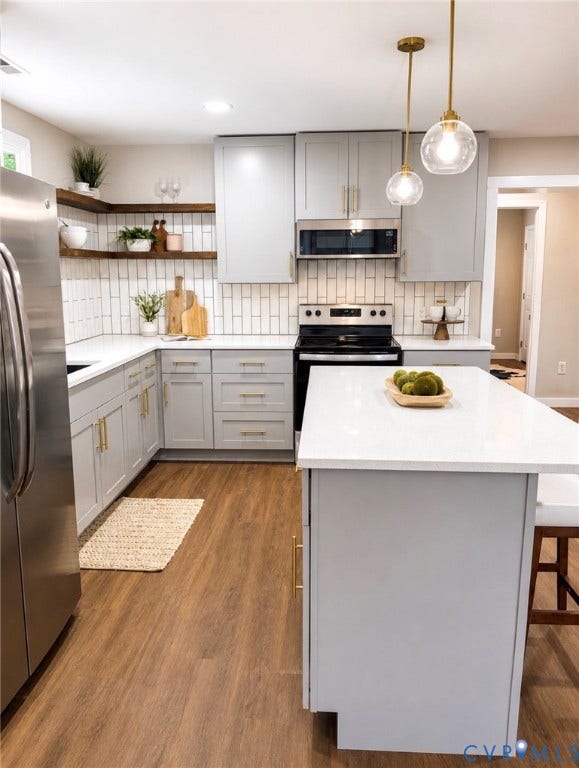 3909 Corbin Street, Wahington Park, Richmond, VA 23222 Kitchen featuring light gray cabinetry, gold-tone hardware, white countertops, wood-finish flooring, and subway tile backsplash