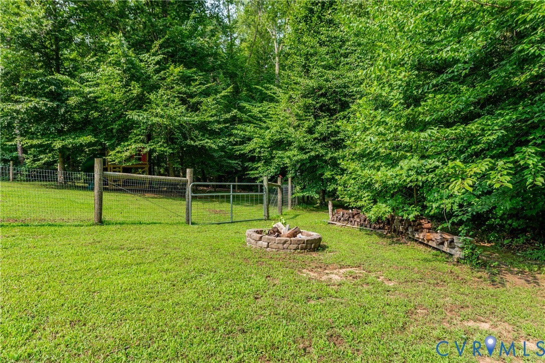 384 Tillar Lane, Mineral, VA 23117 Expansive green lawn with a stone fire pit