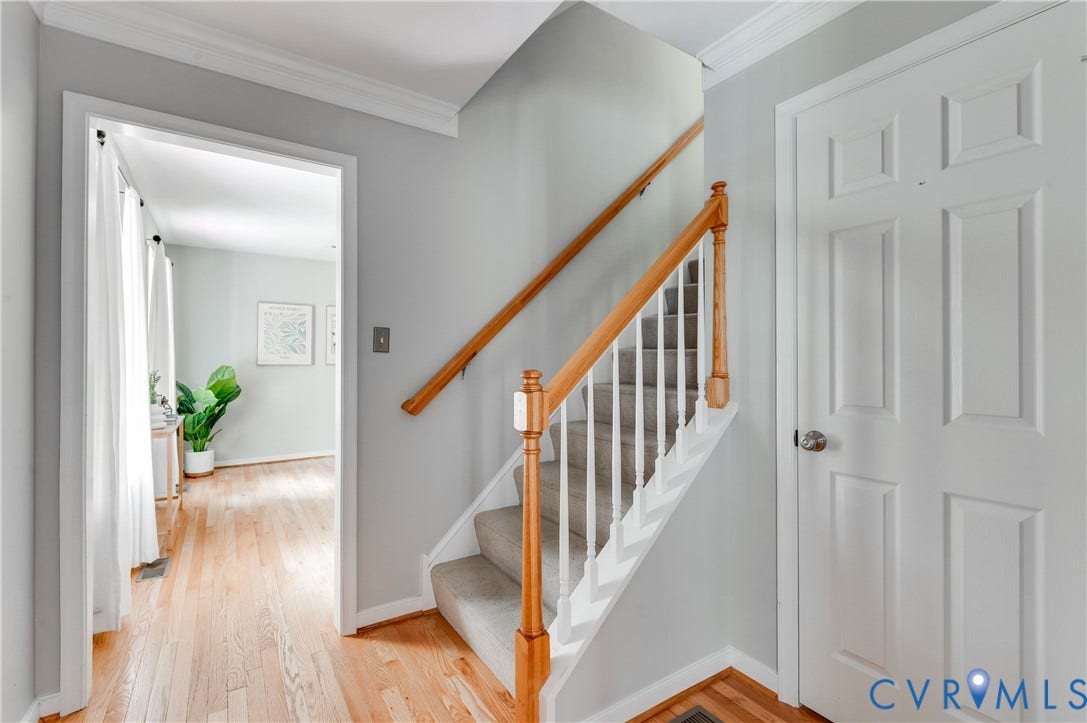 384 Tillar Lane, Mineral, VA 23117 Entryway featuring wood-finish flooring, a carpeted staircase with wood handrails, and crown molding
