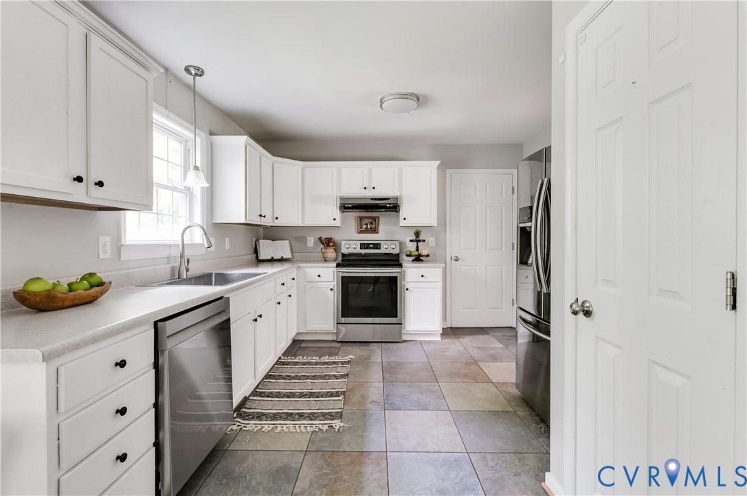384 Tillar Lane, Mineral, VA 23117 Kitchen featuring white cabinetry, light-toned countertops, stainless steel appliances, a double basin sink, and large format tile flooring
