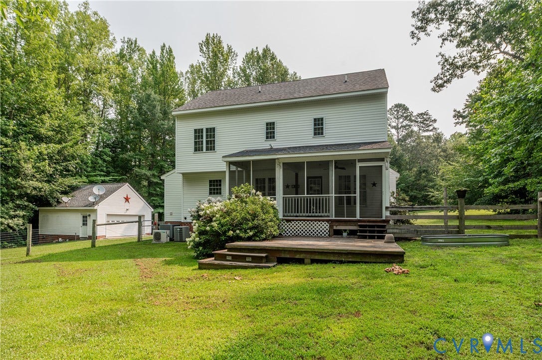 384 Tillar Lane, Mineral, VA 23117 Rear exterior featuring a screened porch, an expansive wood deck, and a detached garage structure
