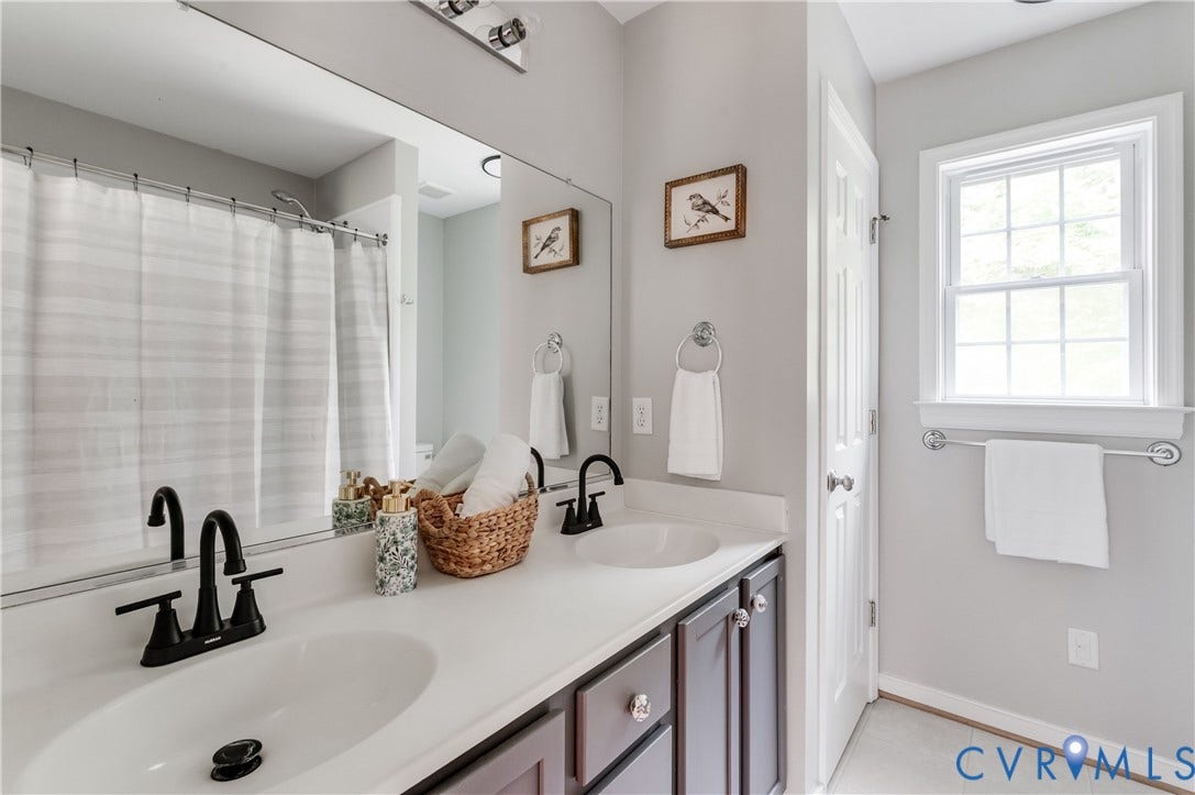 384 Tillar Lane, Mineral, VA 23117 Bathroom featuring a double vanity with white countertops, dark wood-finish cabinetry, and matte black faucets