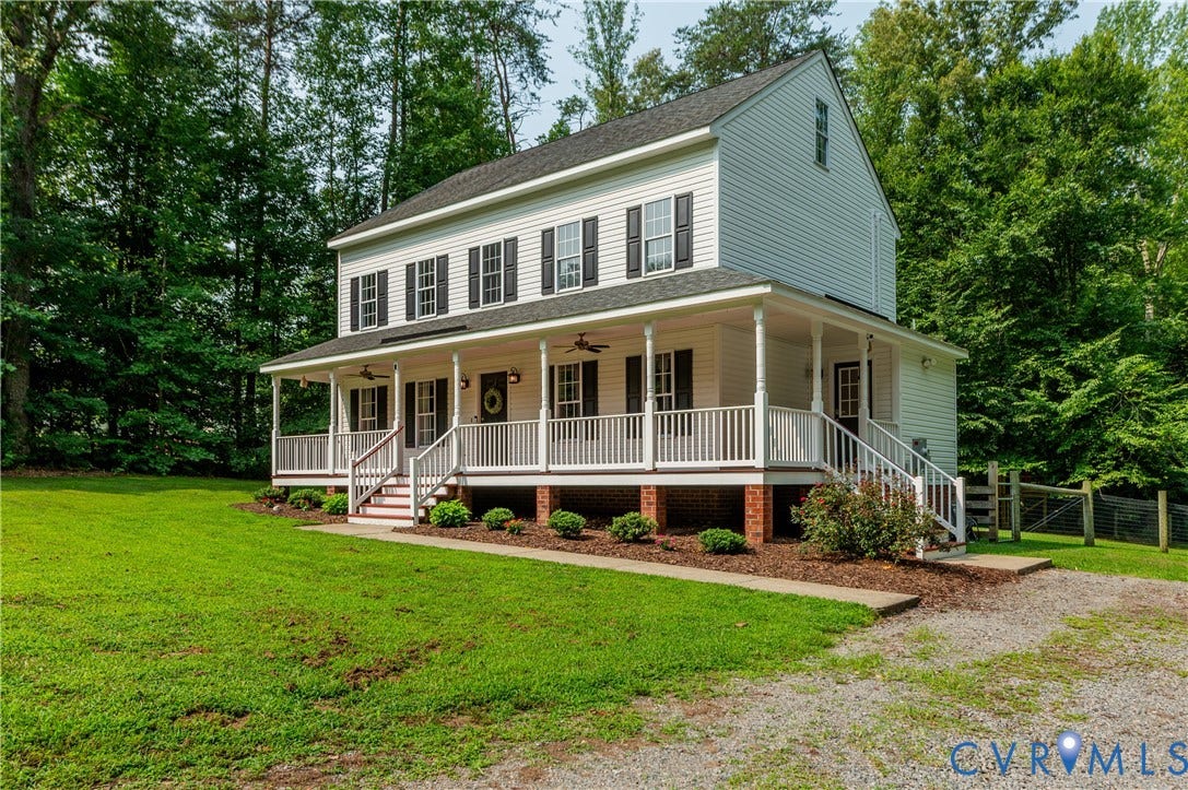 384 Tillar Lane, Mineral, VA 23117 Two-story siding exterior with a wraparound porch featuring a white railing and dark shutters