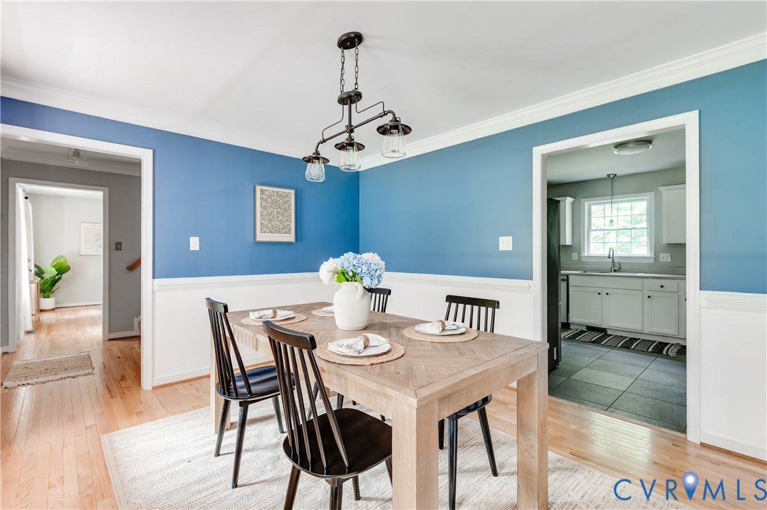 384 Tillar Lane, Mineral, VA 23117 Dining area featuring blue walls with white wainscoting, wood-finish flooring, and a multi-bulb linear chandelier