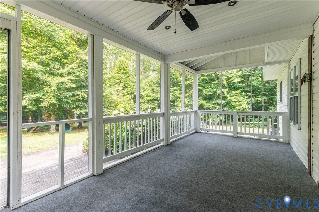 384 Tillar Lane, Mineral, VA 23117 Expansive screened porch featuring a carpeted floor, white railing, and a ceiling fan