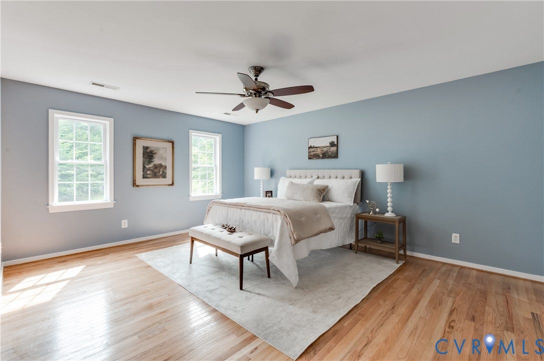 384 Tillar Lane, Mineral, VA 23117 Spacious bedroom featuring light wood-finish flooring, light blue walls, and a ceiling fan with integrated lighting