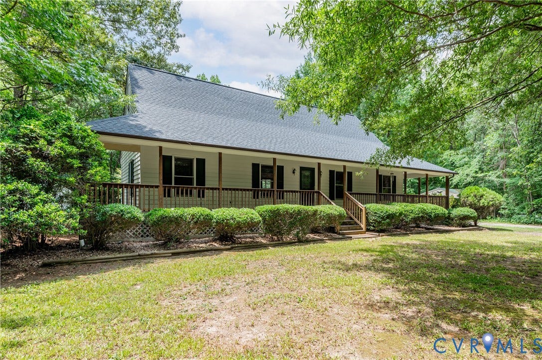 4415 Spoonbill Drive, Powhatan, VA 23139 Ranch-style residence featuring a broad front porch with wood railing and steps, dark shutters, and a grey shingled roof