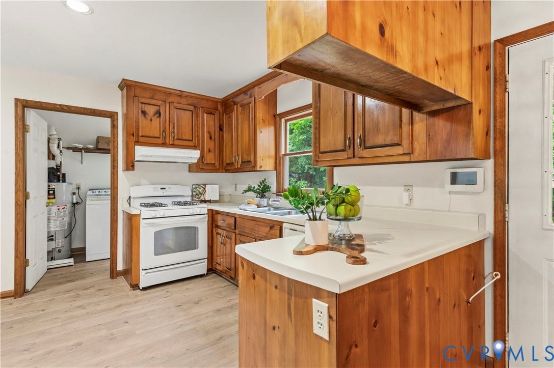 4415 Spoonbill Drive, Powhatan, VA 23139 Kitchen featuring wood cabinetry, white countertops, a white gas range with overhead exhaust, and wood-finish flooring
