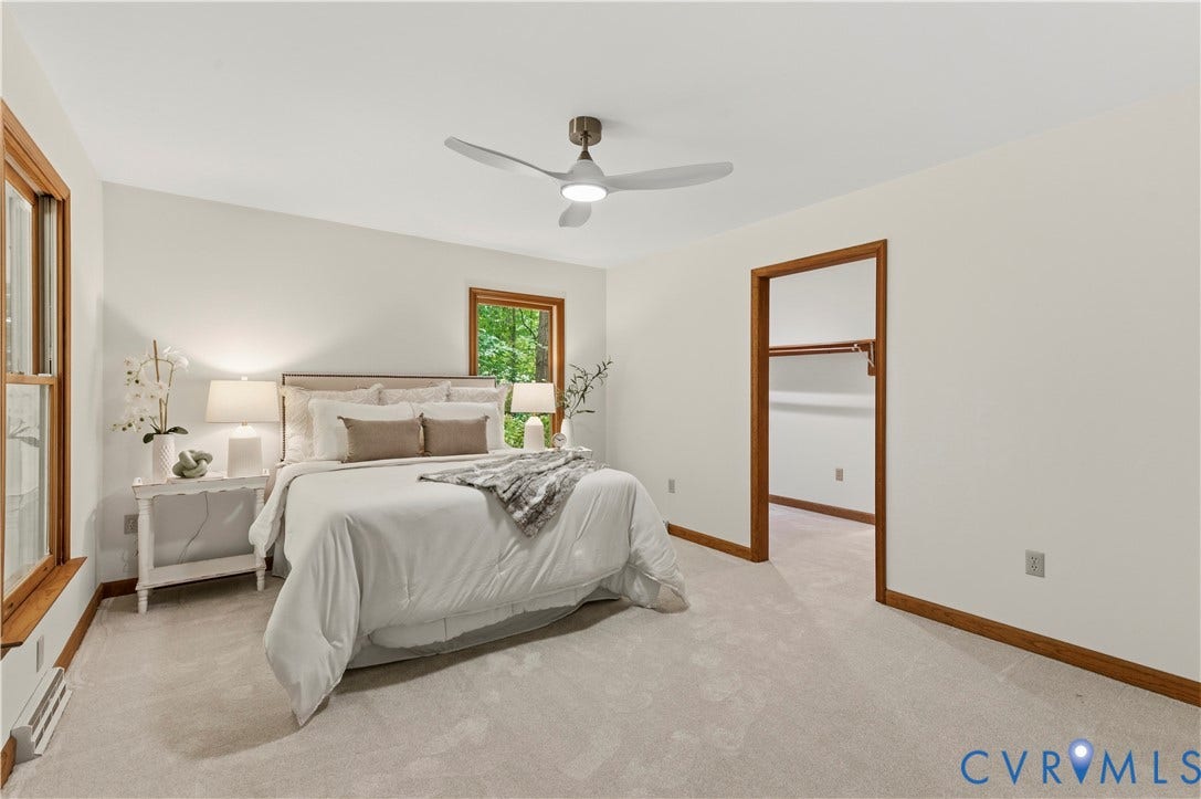4415 Spoonbill Drive, Powhatan, VA 23139 Spacious bedroom featuring light-toned carpeting, white walls, and warm wood trim
