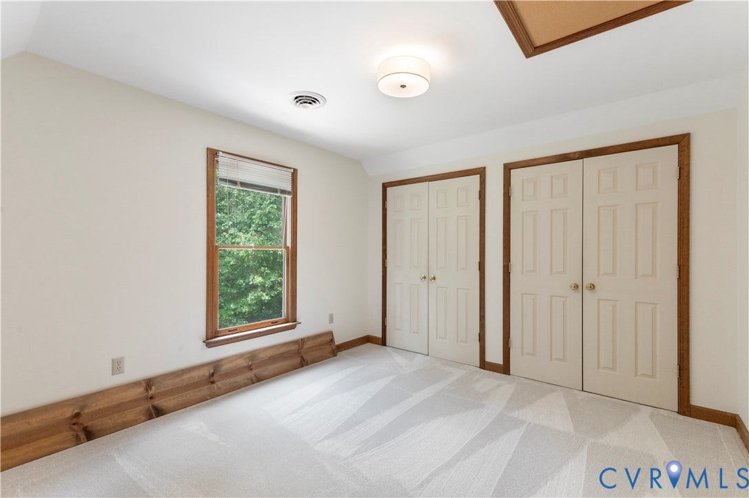 4415 Spoonbill Drive, Powhatan, VA 23139 Room featuring light-toned walls, patterned carpet, and natural wood trim
