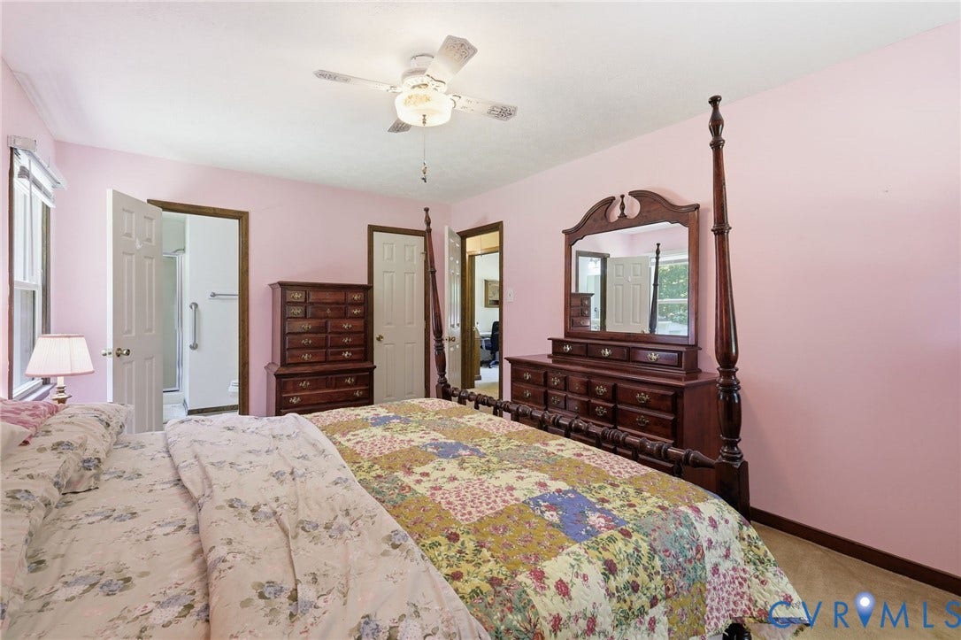 10111 Tunstall Road, New Kent, VA 23124 Bedroom featuring a ceiling fan with integrated lighting, a window with a white frame, and a white paneled door