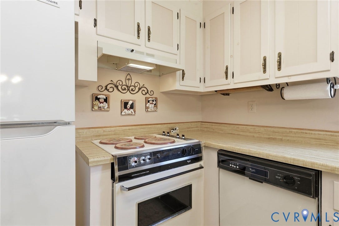 10111 Tunstall Road, New Kent, VA 23124 Kitchen featuring white upper cabinetry, light-toned countertops, a white refrigerator, a built-in range, and a built-in dishwasher