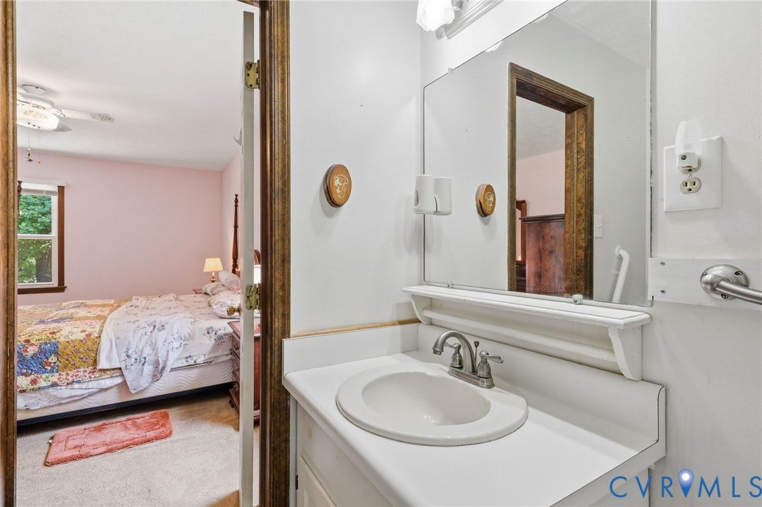 10111 Tunstall Road, New Kent, VA 23124 Bathroom vanity with an integrated white sink, a chrome two-handle faucet, and an overhead lighting fixture