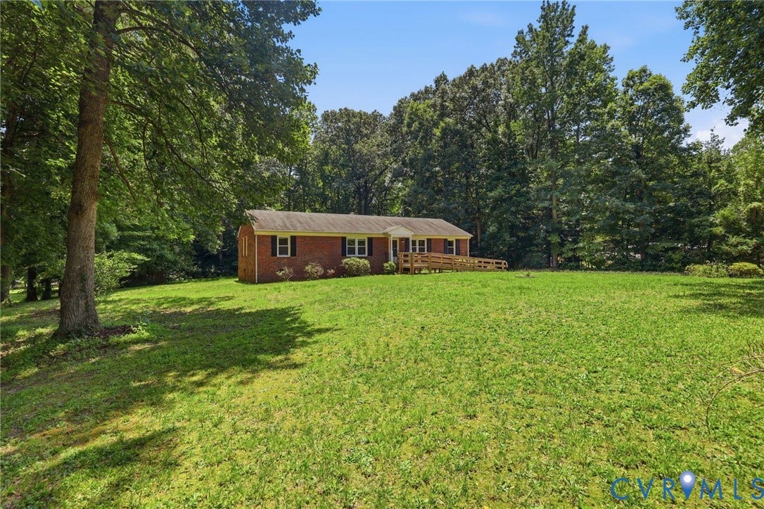 10111 Tunstall Road, New Kent, VA 23124 Brick exterior ranch-style home featuring a covered front entry and a wooden accessibility ramp