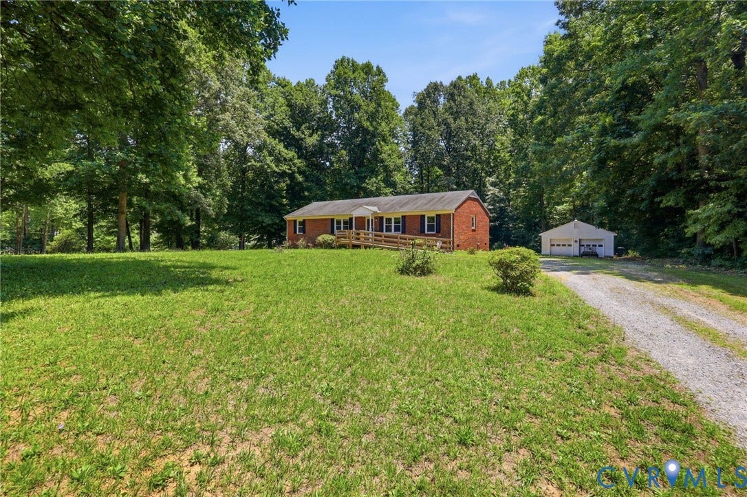 10111 Tunstall Road, New Kent, VA 23124 Brick ranch-style home featuring a wooden ramp entry and black window shutters