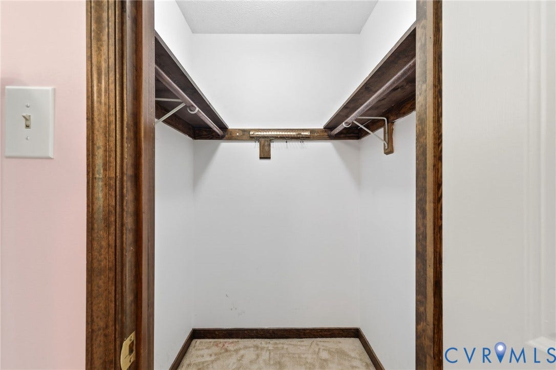 10111 Tunstall Road, New Kent, VA 23124 Closet space featuring wood-finish shelving and a hanging rod