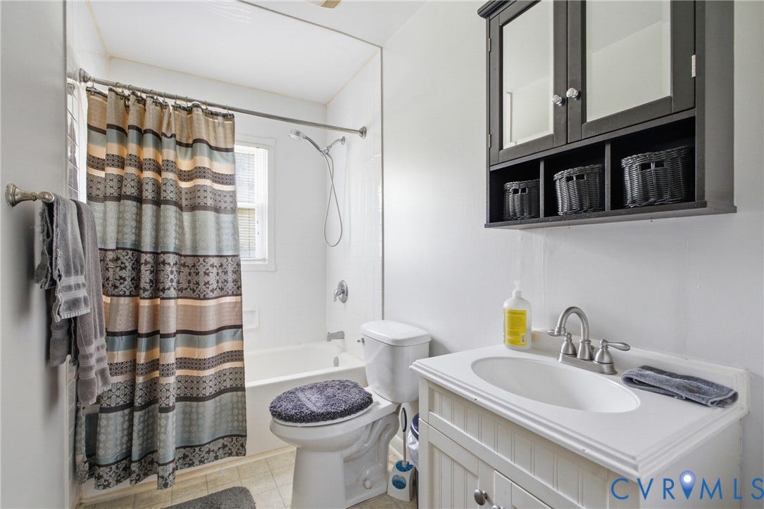 303 W 8th Street, Town Of Mineral, Mineral, VA 23117 Bathroom featuring a white vanity with an integrated sink, brushed nickel faucet, and beadboard paneling
