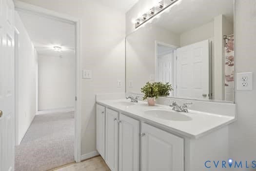 5213 Wheat Ridge Place, Chappell Ridge, Glen Allen, VA 23059 Double vanity with white cabinetry and integrated sinks, illuminated by an overhead bar light fixture