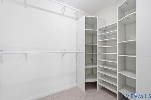 5213 Wheat Ridge Place, Chappell Ridge, Glen Allen, VA 23059 Spacious walk-in closet featuring white built-in shelving, multiple hanging rods, and carpeting