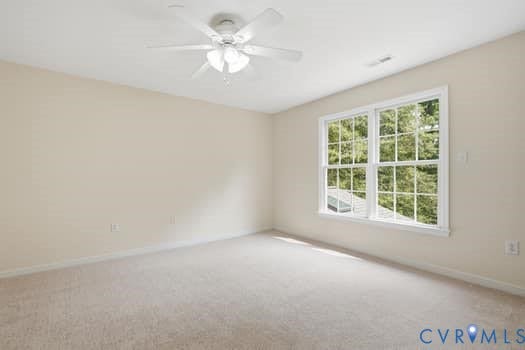 5213 Wheat Ridge Place, Chappell Ridge, Glen Allen, VA 23059 Bright room featuring a large window with muntins, neutral-toned walls, and carpet flooring