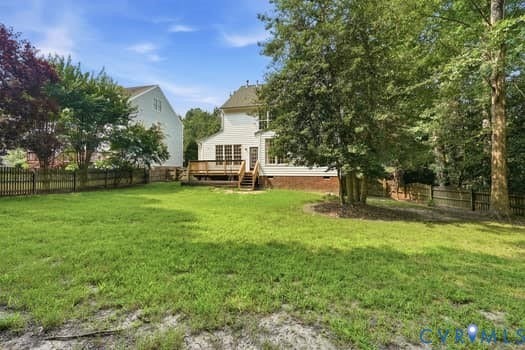 5213 Wheat Ridge Place, Chappell Ridge, Glen Allen, VA 23059 Expansive backyard featuring a manicured lawn, a multi-level wood deck, and mature trees providing natural screening
