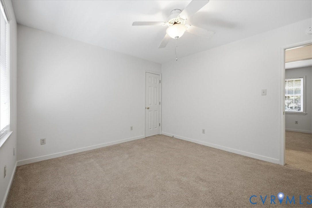 Spacious bedroom #3room has neutral carpeting, a ceiling fan with integrated lighting, and white trim