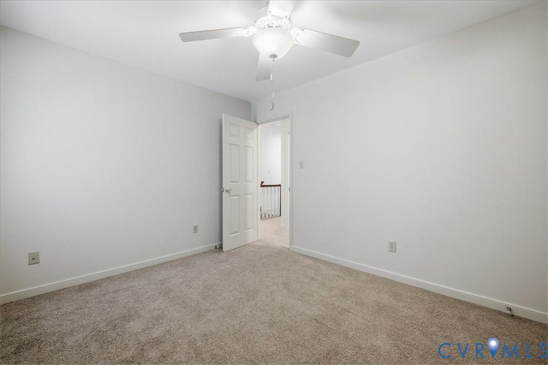 Bedroom #2 has white walls, and white trim