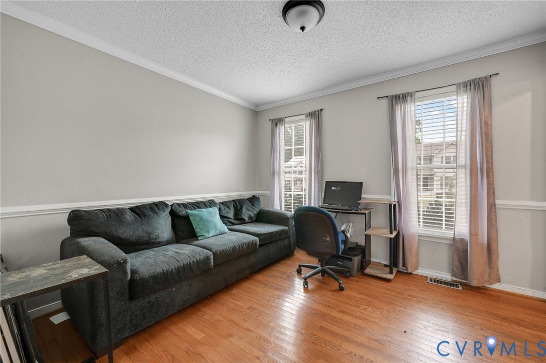 1207 Wycliff Court, Richmond, VA 23236 Spacious room featuring wood-finish flooring, two windows with blinds, a ceiling-mounted light fixture, crown molding, and wainscoting