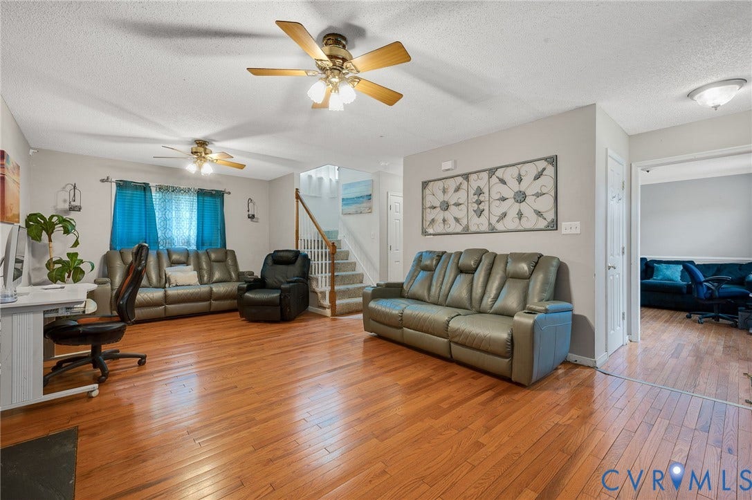 1207 Wycliff Court, Richmond, VA 23236 Living area featuring wood-finish flooring, light grey wall paint, and multiple ceiling fans with integrated lighting