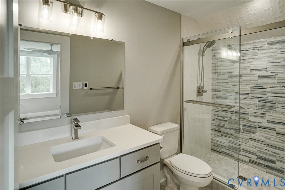 1732 Fishers Pond Drive, Maidens, VA 23102 Contemporary bathroom featuring a spacious vanity with an integrated rectangular sink and quartz-finish countertop