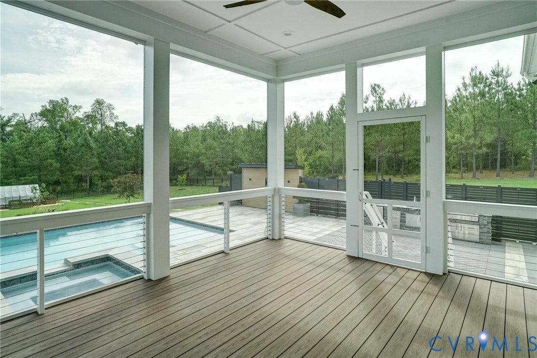 1732 Fishers Pond Drive, Maidens, VA 23102 Screened porch featuring wood-finish flooring, white ceiling fan, and white wood-frame door