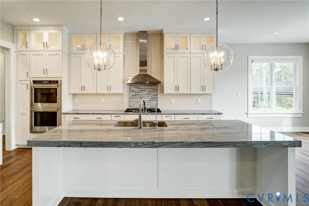1732 Fishers Pond Drive, Maidens, VA 23102 Contemporary kitchen featuring a large island with a dual basin sink, stainless steel appliances, white cabinetry, and recessed lighting