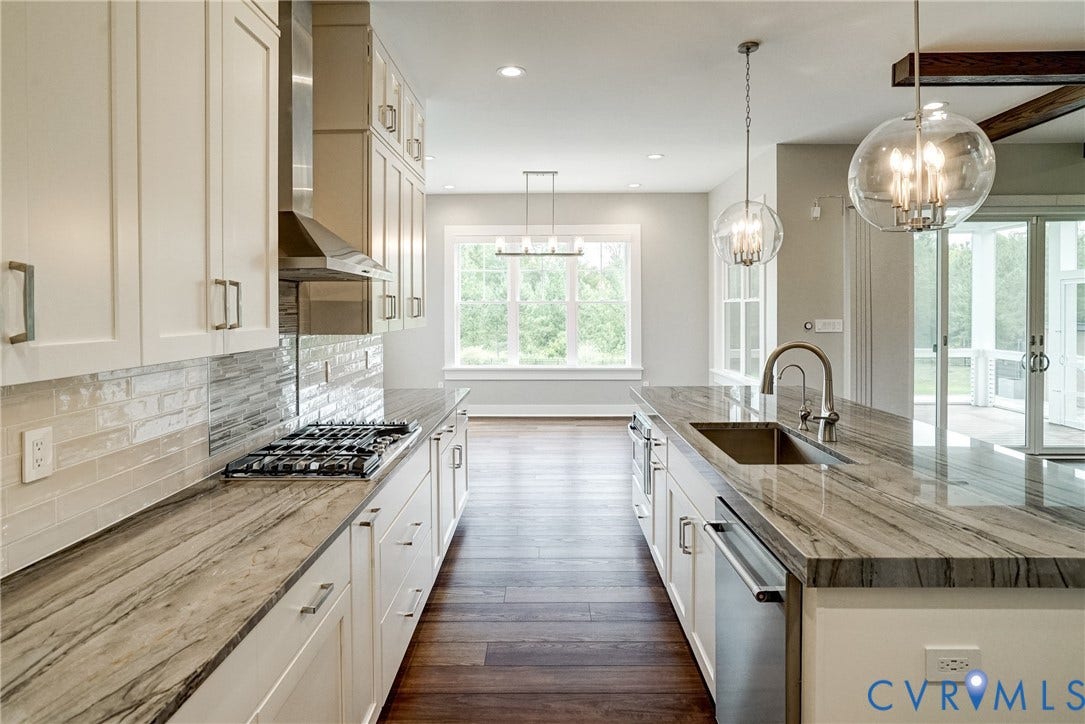 1732 Fishers Pond Drive, Maidens, VA 23102 Open-concept kitchen featuring white cabinetry, stone countertops, a gas range with a stainless steel hood, an undermount sink with a gooseneck faucet, and hardwood flooring